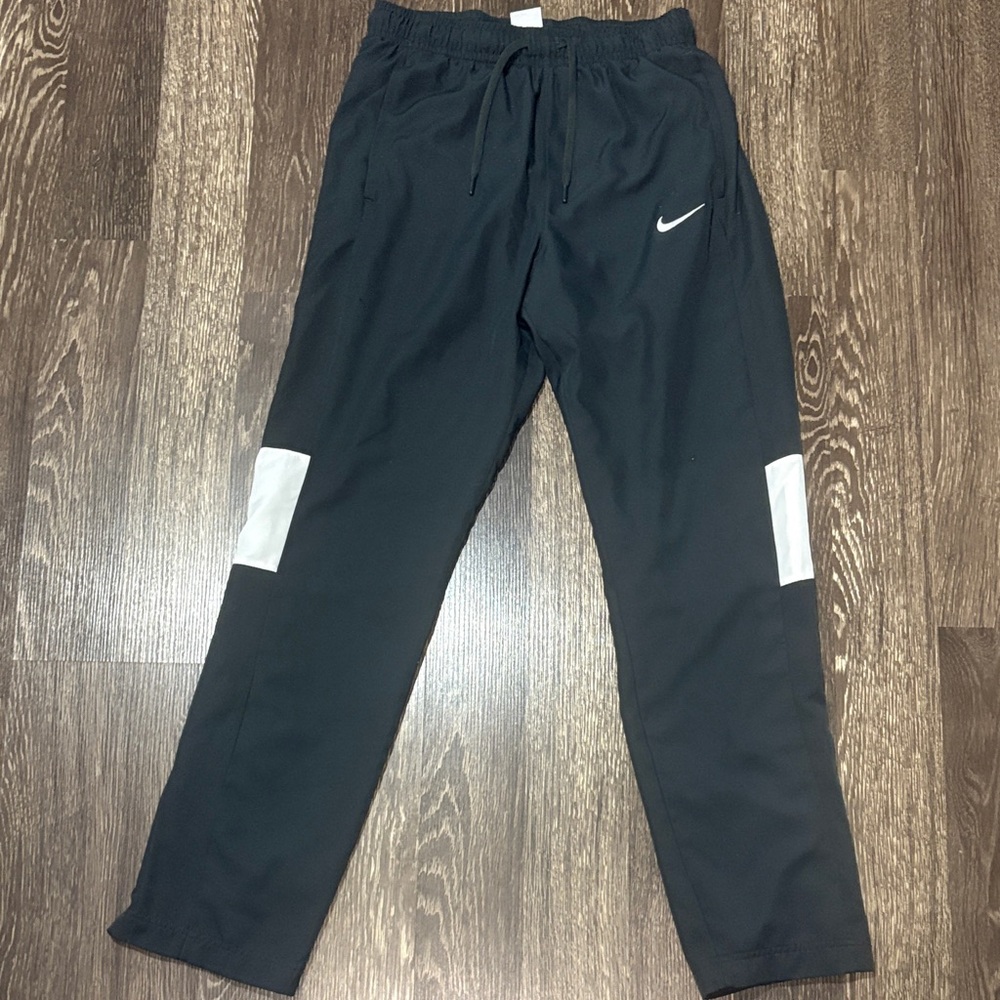 Nike dri-fit sweatpants dark gray and white size medium with snap opening on leg